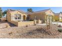 Inviting front yard with low stucco wall, desert landscaping, and small sitting area at 1466 Fieldbrook St, Henderson, NV 89052