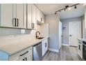 Bright kitchen boasts stainless steel appliances, quartz countertops, and modern track lighting at 1645 Chestnut St, Henderson, NV 89011
