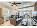Bright living room with modern furniture, a stylish ceiling fan, and plenty of natural light at 1645 Chestnut St, Henderson, NV 89011