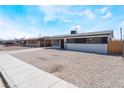 Single-story house with a low-maintenance gravel yard and neutral exterior paint at 1648 J St, Las Vegas, NV 89106
