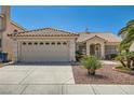 Inviting single-story home boasts desert landscaping, tile roof, and a spacious two-car garage at 1751 Juniper Twig Ave, Las Vegas, NV 89183