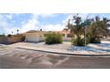 Street view of a charming single-story home with desert landscaping, attached garage, and neighborhood street sign at 1905 Aquarius Dr, Las Vegas, NV 89102