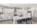 Stylish kitchen featuring quartz countertops, stainless steel appliances, and a breakfast bar at 191 Reed Ln, Henderson, NV 89074