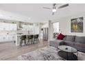 Open-concept living area featuring a spacious kitchen with stainless steel appliances and a comfortable gray sectional sofa at 191 Reed Ln, Henderson, NV 89074