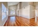 Beautiful living room featuring hardwood floors, high ceilings, natural light and an elegant chandelier at 1933 Coralino Dr, Henderson, NV 89074