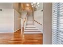 Elegant staircase with wooden handrail and white risers, complemented by hardwood flooring throughout at 1933 Coralino Dr, Henderson, NV 89074