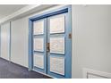 Condominium hallway features an ornate door with decorative, raised floral squares at 205 E Harmon Ave # 306, Las Vegas, NV 89169