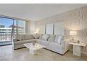 Living room featuring neutral decor, comfortable seating, and city view at 205 E Harmon Ave # 306, Las Vegas, NV 89169