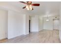 Open concept living room with ceiling fan, light walls, and wood flooring at 23 E Agate Ave # 207, Las Vegas, NV 89123