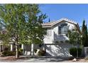 Inviting two-story home with a well-maintained front yard, a two-car garage, and a charming exterior design at 2305 Flower Spring St, Las Vegas, NV 89134