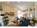 Bright and open living room with vaulted ceilings, elegant decor, and abundant natural light at 2305 Flower Spring St, Las Vegas, NV 89134