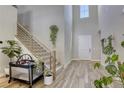 Welcoming foyer featuring high ceilings, staircase with modern railings, and contemporary tile flooring at 253 Malpaso St, Las Vegas, NV 89138