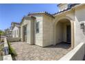 Inviting front entrance featuring a covered porch, stone accents, and a paved walkway leading to the front door at 253 Malpaso St, Las Vegas, NV 89138