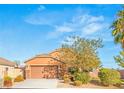 Charming one-story home with a two-car garage and desert landscaping in front at 2720 Mickey Mantle Ct, Las Vegas, NV 89108