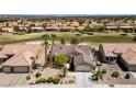 Stunning home situated on the golf course with lush green landscaping and mature shade trees at 3016 High Range Dr, Las Vegas, NV 89134