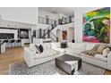 Bright living room with a high ceiling, an upper level view, a sectional sofa, and an open floor plan at 3038 Villanelle Ave, Henderson, NV 89044
