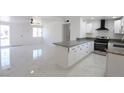 Modern kitchen featuring white cabinets, stainless steel appliances, and an island at 3115 Wright Ave, North Las Vegas, NV 89030