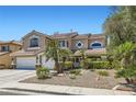 Elegant two-story home boasting manicured landscaping with decorative rock and mature palm trees at 3749 Climbing Rose St, Las Vegas, NV 89147