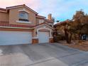 Charming two-story home with a three-car garage and desert landscaping showcasing beautiful curb appeal at 3749 Climbing Rose St, Las Vegas, NV 89147