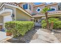 Close up front entrance featuring manicured bushes, stone accents and a pathway leading to the front door at 3749 Climbing Rose St, Las Vegas, NV 89147