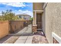 Inviting front entrance with a secure gate and a paved walkway leading to the door at 415 Carsin Wayne Ct, North Las Vegas, NV 89031