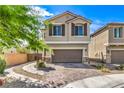 Charming two-story home with a well-manicured front yard, a driveway, and a two-car garage at 415 Carsin Wayne Ct, North Las Vegas, NV 89031