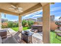 Relaxing covered patio featuring an outdoor seating area, hot tub, and artificial grass at 415 Carsin Wayne Ct, North Las Vegas, NV 89031