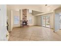 Bright living room with a cozy fireplace and sliding glass doors leading to the backyard at 4197 Tolkien Ave, Las Vegas, NV 89115