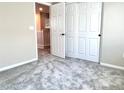 Cozy bedroom featuring neutral walls, plush carpet, and closet with double sliding doors at 5060 Serene Skies St, Las Vegas, NV 89130