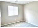 Neutral bedroom with light gray carpet, a window with blinds, and ample natural light at 5060 Serene Skies St, Las Vegas, NV 89130