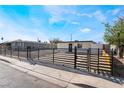 Cozy single-story house showcasing black horizontal metal fence and well-maintained landscaping at 5069 Hallet Dr, Las Vegas, NV 89122