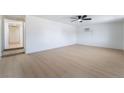 Bright living room with wood floors, ceiling fan, and an entrance to the hallway at 5069 Hallet Dr, Las Vegas, NV 89122