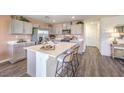 Modern kitchen with stainless steel appliances, kitchen island and gray cabinets at 5722 Sunset Sedona St # Lot 7, North Las Vegas, NV 89081