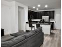 Cozy living space with sleek black kitchen cabinets and an inviting open-concept design at 649 Ryan Peak Ln, Henderson, NV 89011