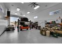 Spacious garage interior featuring a car lift and ample storage space for multiple vehicles and equipment at 6781 Alpine Brooks Ave, Las Vegas, NV 89130