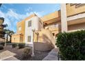 Multi-level condo building featuring a unique architecture with desert landscaping at 6857 Tamarus St # 202, Las Vegas, NV 89119