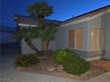 Well-maintained front yard with desert landscaping and a mature palm tree providing curb appeal at 7417 Red Eagle St, Las Vegas, NV 89131