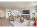 Bright living room featuring stylish seating, a patterned rug, and a decorative media console at 7454 Bosco Brook Dr # Lot 48, North Las Vegas, NV 89084