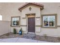 Inviting home exterior featuring a covered entryway and well-maintained landscaping around the front at 7915 Pandora Sky St # 403, North Las Vegas, NV 89084
