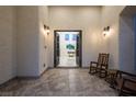 Covered entrance patio with double doors and a view into the open floor plan at 8000 Clock Tower Ct Ct, Las Vegas, NV 89117