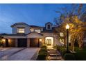 Charming two-story home with a three-car garage, stone accents, and manicured front yard at 8000 Clock Tower Ct Ct, Las Vegas, NV 89117