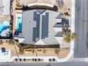 Aerial view of home with pool, tile roof, solar panels and well-maintained landscaping at 8811 Pauley Hills St, Las Vegas, NV 89131