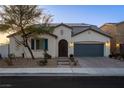 Charming single-story home with a landscaped front yard, solar panels, and a two-car garage at 8811 Pauley Hills St, Las Vegas, NV 89131