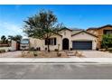 Charming single-story home with desert landscaping, brick driveway and two car garage at 8811 Pauley Hills St, Las Vegas, NV 89131