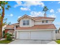 Stunning two-story home with a red-tiled roof, featuring a dual-car garage and meticulous landscaping at 9709 Terrace Green Ave, Las Vegas, NV 89117