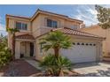Inviting two-story home with a red tile roof, desert landscaping, and attached two-car garage at 10103 Flagstaff Butte Ave, Las Vegas, NV 89148