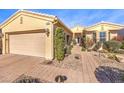 Attractive single-story home with desert landscaping, a brick walkway, and a two-car garage at 10290 Profeta Ct, Las Vegas, NV 89135