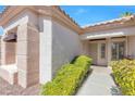 Inviting front entrance with well-maintained bushes, decorative pillars, and a security screen door at 10920 Black Ledge Ave, Las Vegas, NV 89134