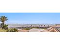 Elevated view shows Las Vegas skyline and desert landscape with palm trees, and terracotta roofs at 10921 Grand Haven Ave, Las Vegas, NV 89134