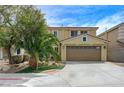 Inviting two-story home featuring a well-maintained lawn, desert landscaping, and attached two-car garage at 1131 Sax Fifth Ave, Henderson, NV 89052